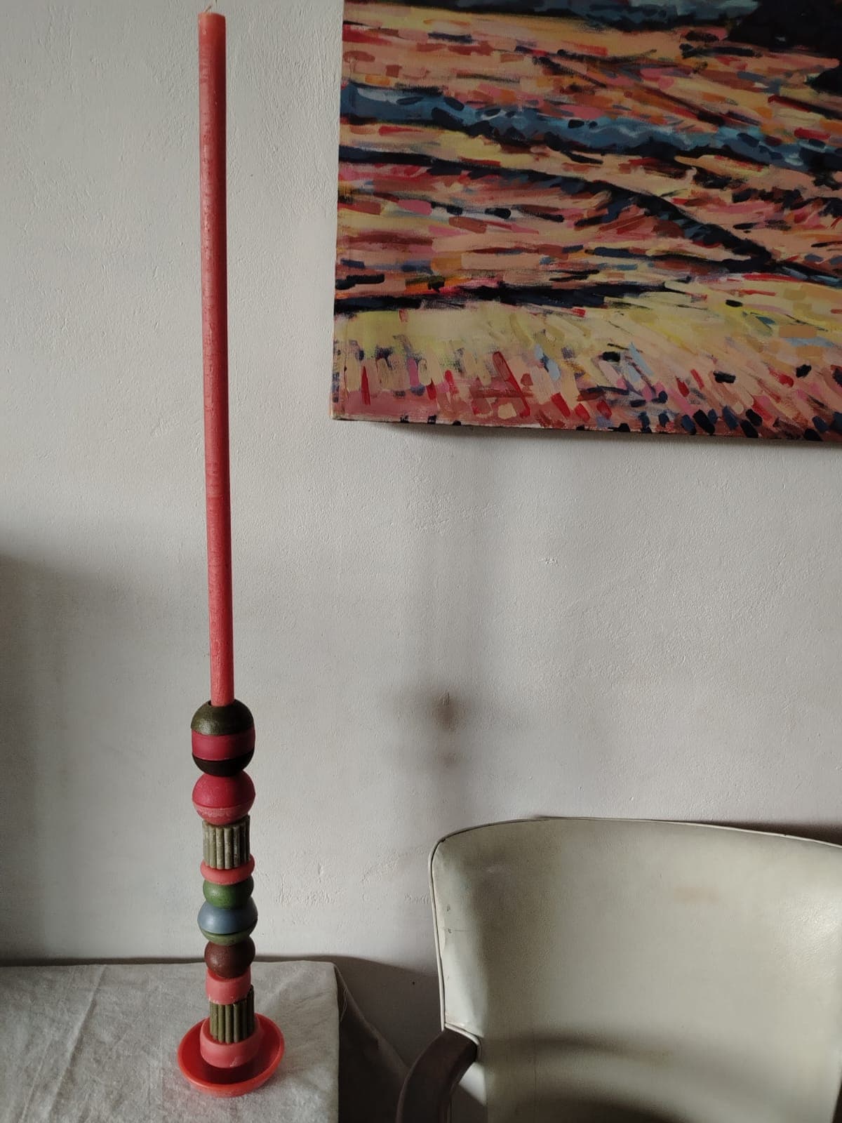Tall statement candle with artwork backdrop